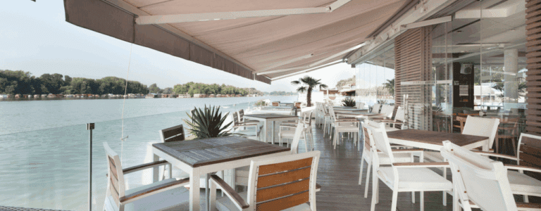 Restaurant dining area shaded by an outdoor awning